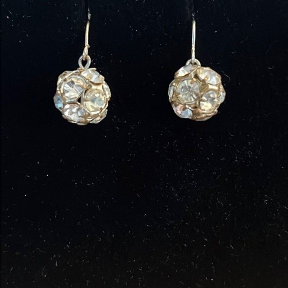 Handcrafted silver tone earrings with a clear colored stones.